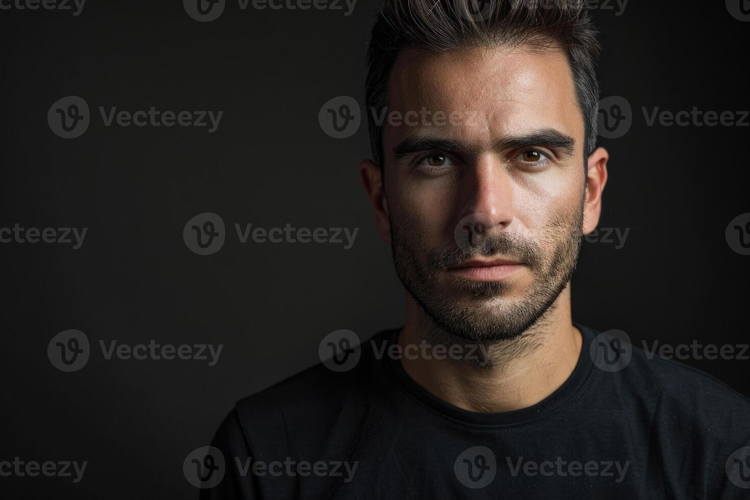 Portrait of determined goodlooking man wearing black shirt black background. photo