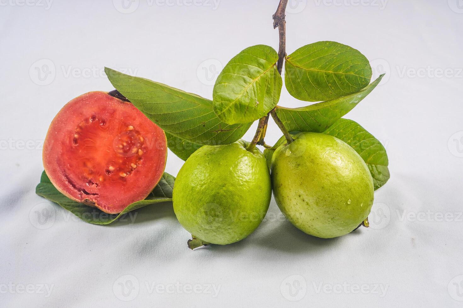 Guava isolated. Collection of red fleshed guava fruit with yellowish green skin and leaves isolated on white background. photo