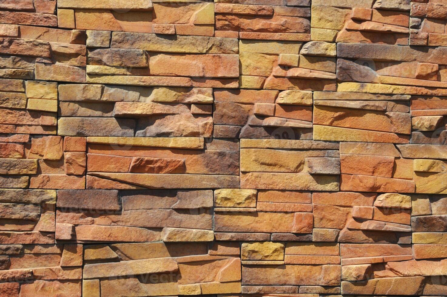 Red brown brick wall. Decorative facing stone. Fragment of the building facade. photo