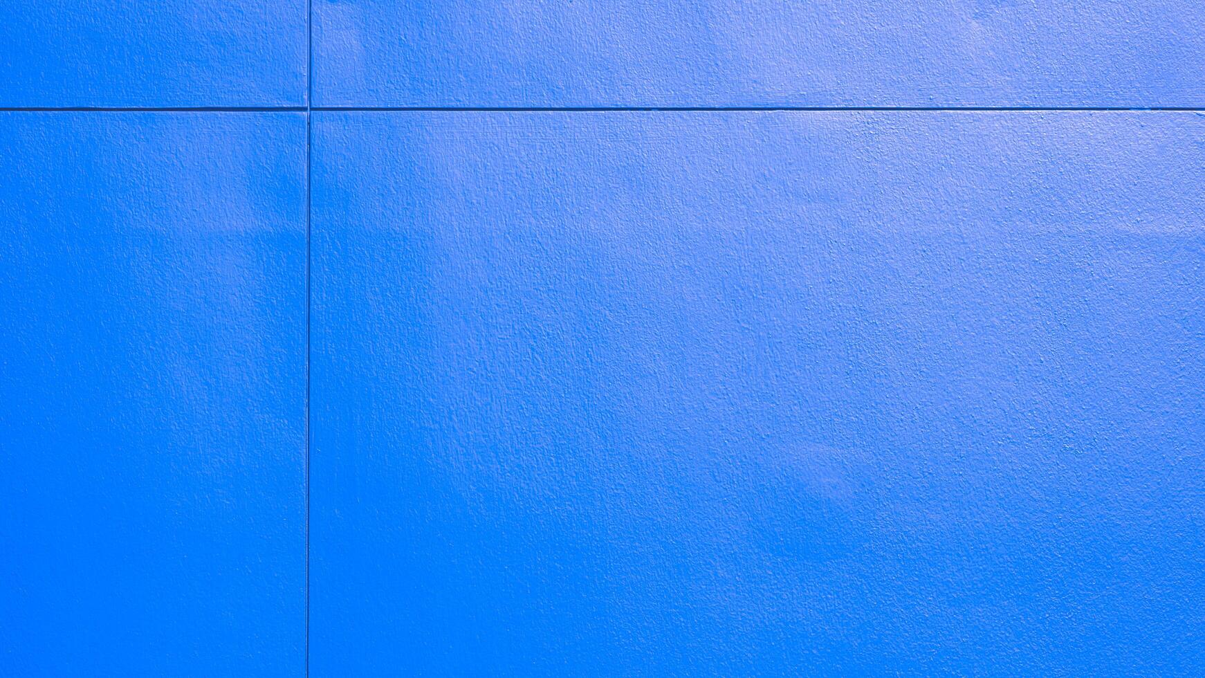 Background and texture of prefabricated blue fiber cement smartboard and seam cross lines on exterior building wall surface photo