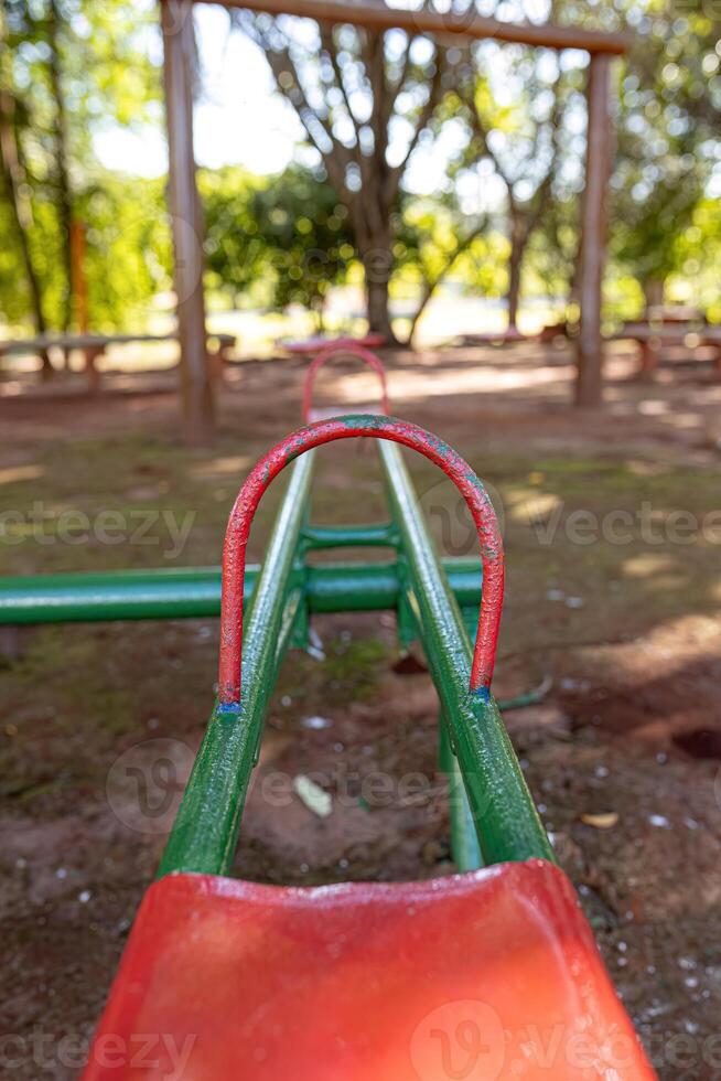 green and red metal seesaw photo