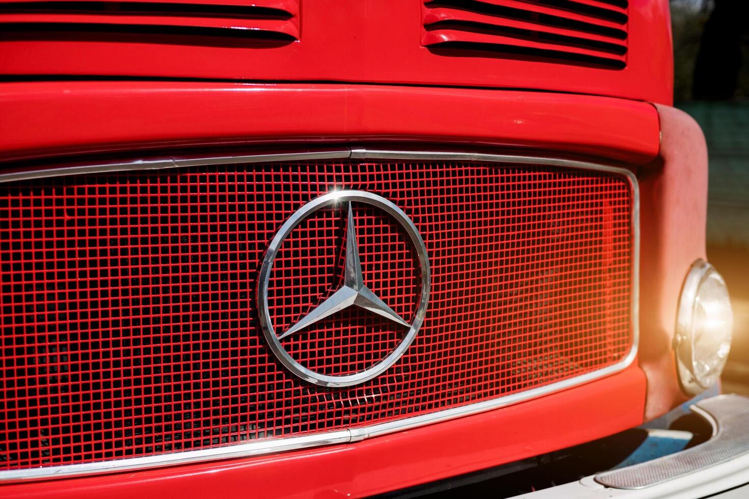 Minsk, Belarus, April 18, 2024 - Vintage Logo of red Mercedes truck photo