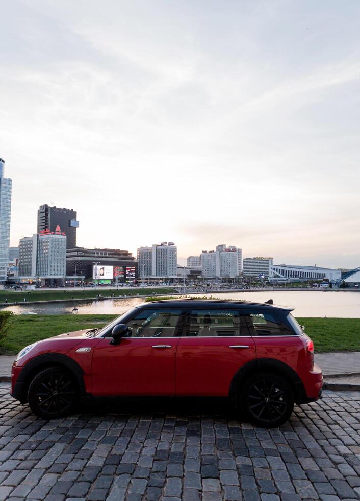 Minsk, Belarus, April 17, 2024 - Side view of red mini cooper photo
