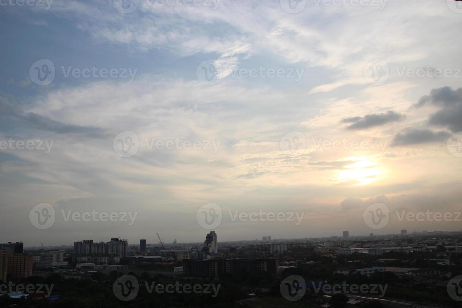 heaven cloudy sky day evening dusk time with sunlight ray from between clouds with city town background photo