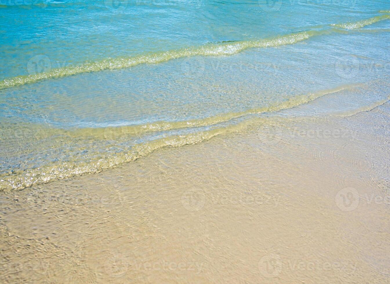 Light reflection on the surface of movement sea on sand beach photo