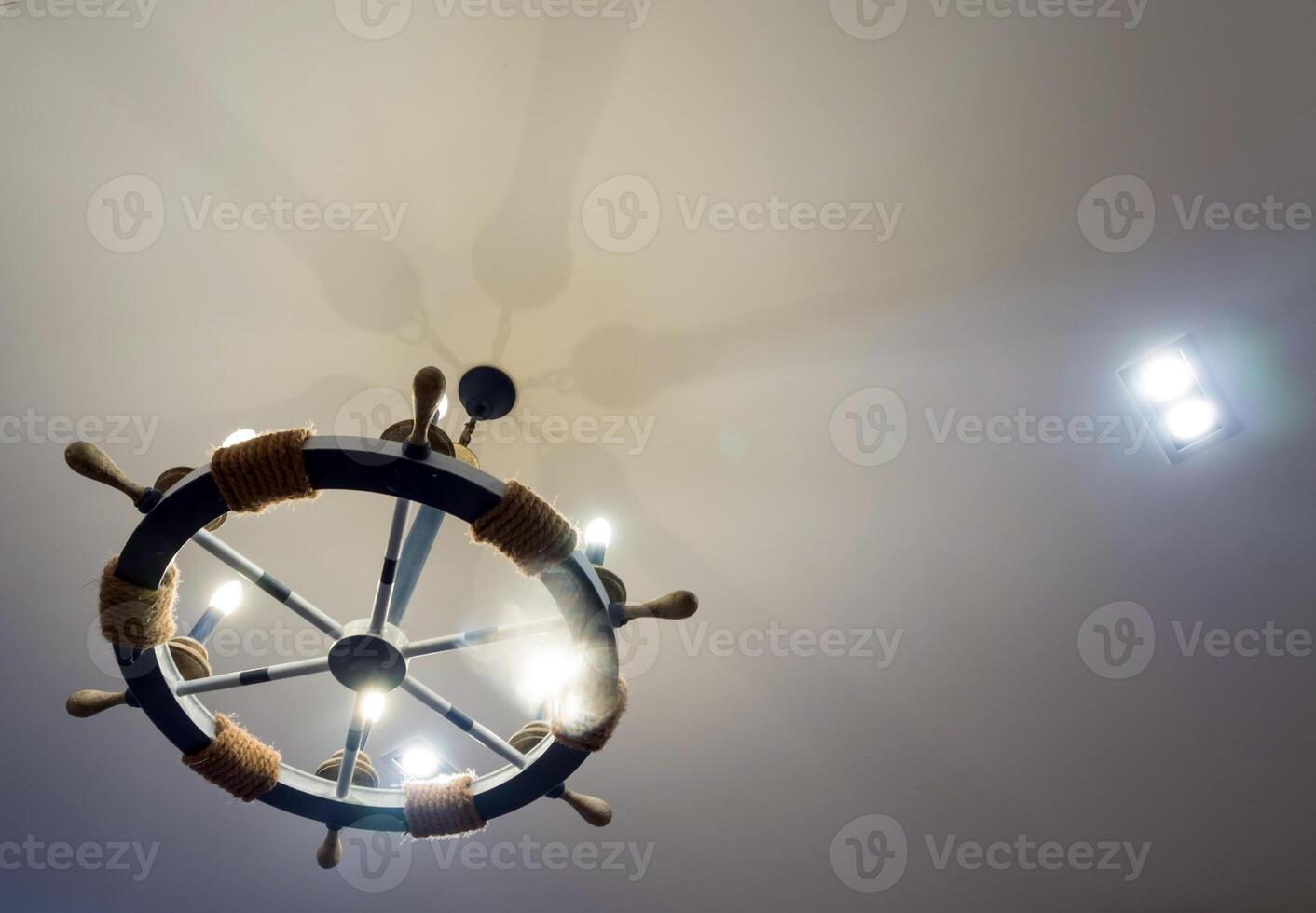 The steering wheel of the boat was adapted into a ceiling lamp photo