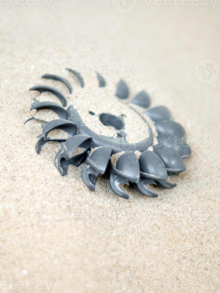 Plastic Pelton water turbine on sand with out water photo