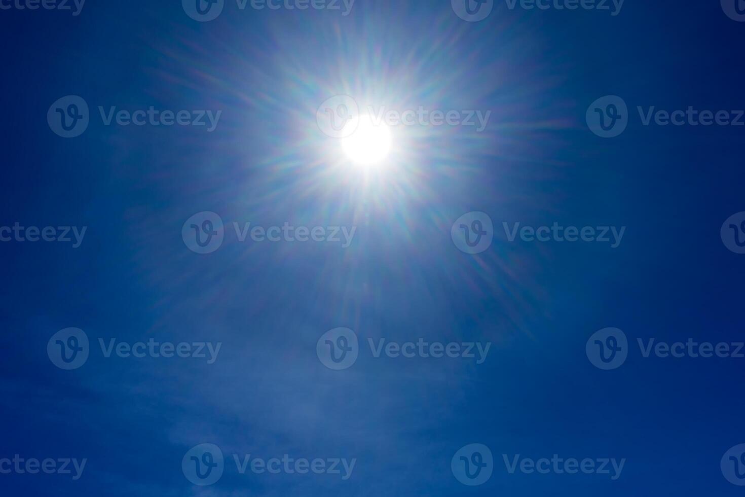 Sun rays on blue sky with bottom space. photo