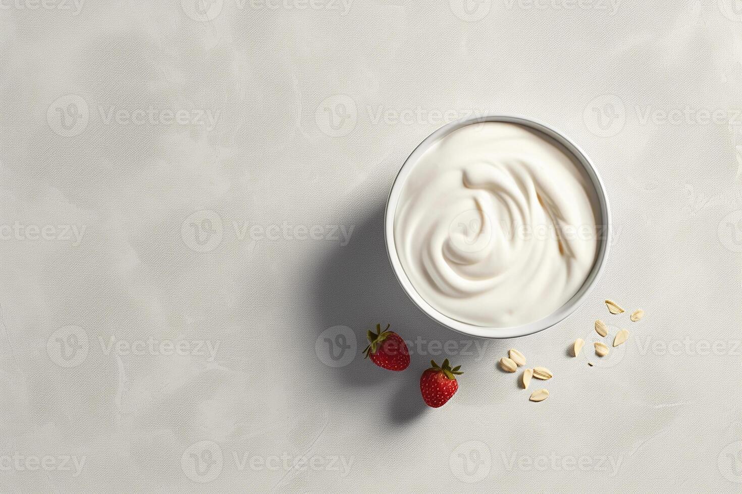 Bowl of strawberry yogurt surrounded by fresh strawberries on a white textured surface. photo