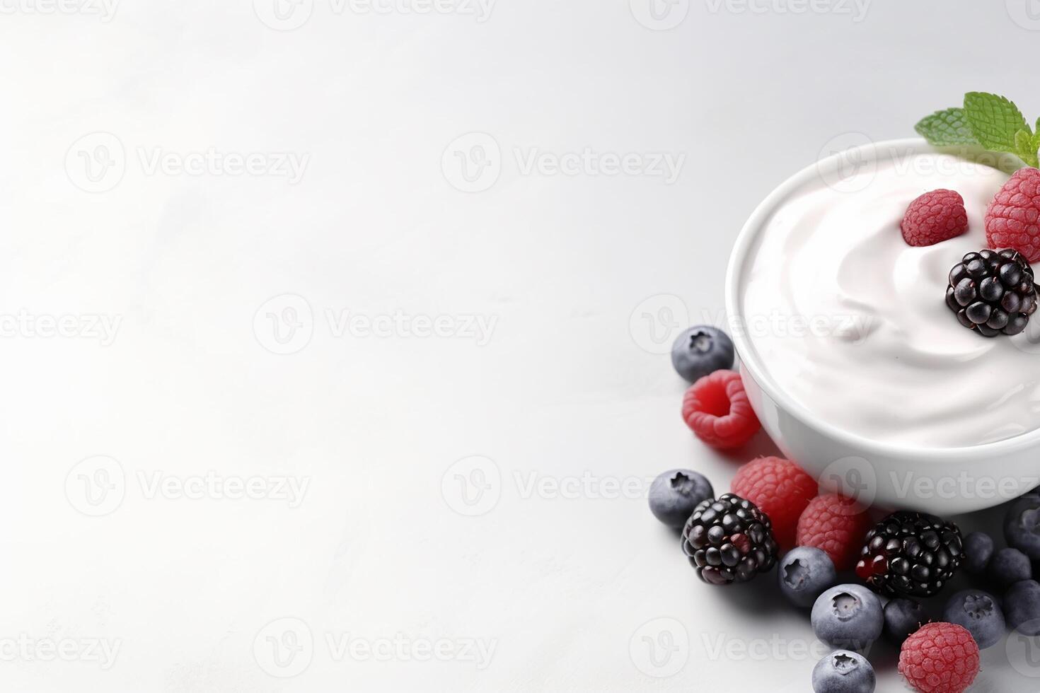 Bowl of yogurt with fresh strawberries, raspberries, and blueberries on white background. photo