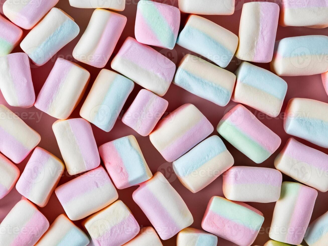 many marshmallows on pastel pink background photo