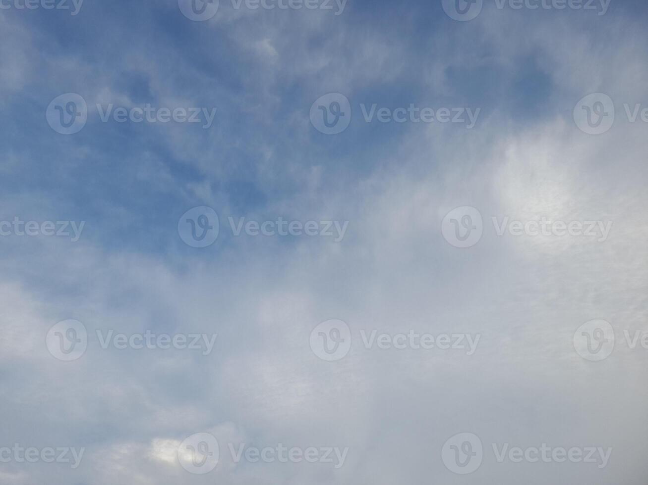 Beautiful white clouds on deep blue sky background. Large bright soft fluffy clouds are cover the entire blue sky. photo