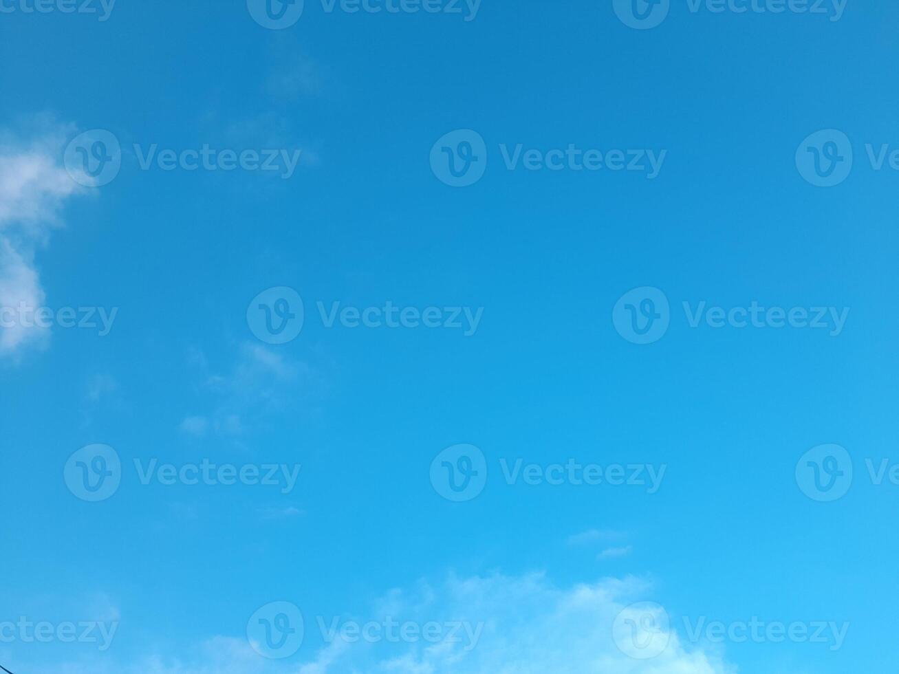 Beautiful white clouds on deep blue sky background. Large bright soft fluffy clouds are cover the entire blue sky. photo