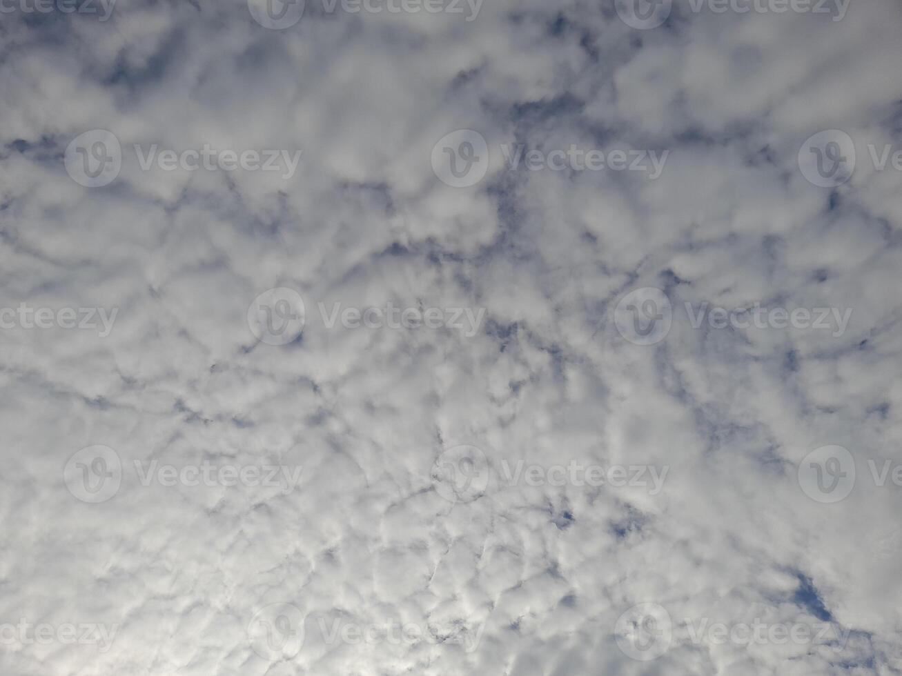 Beautiful white clouds on deep blue sky background. Large bright soft fluffy clouds are cover the entire blue sky. photo