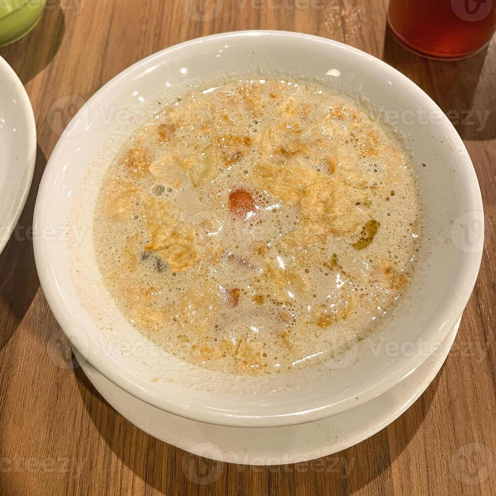 Soto Betawi. Traditional beef and offal soup from Betawi, Jakarta. served on bowl , Top View photo