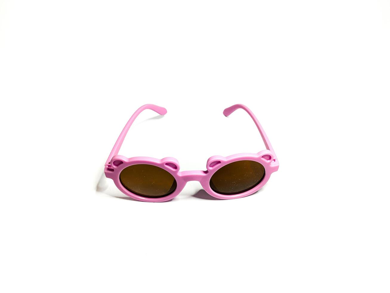 Isolated image of a pink child's glasses. Taking pictures from the side photo