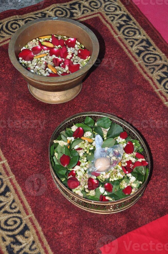 The procession is stepping on Javanese traditional wedding eggs photo