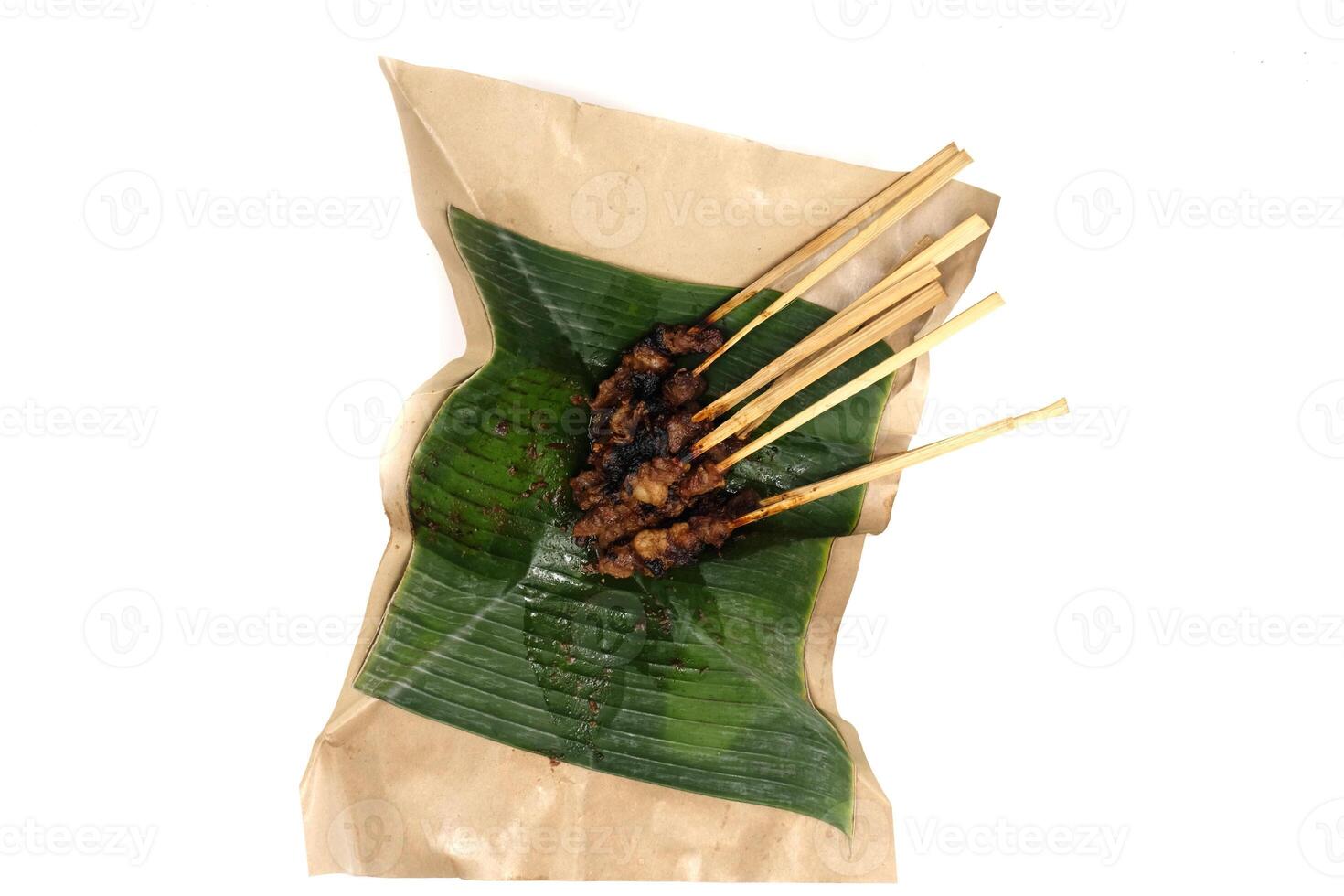 goat satay skewers and banana leaf photo