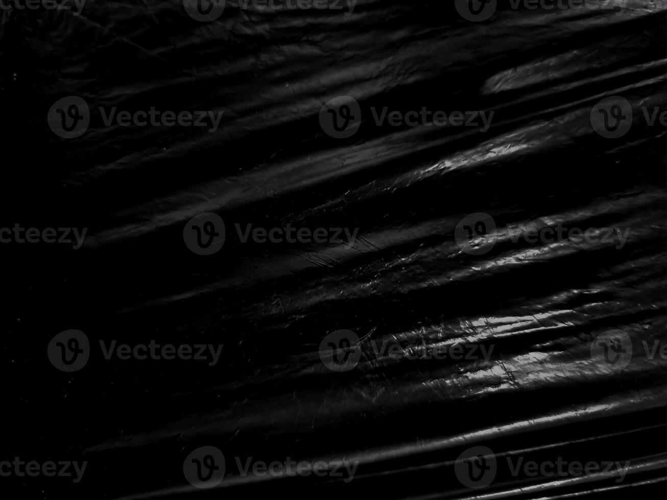 a black transparent plastic texture with hole for poster and cover art. realistic plastic wrap for overlay, copy space and photo effect. wrinkled plastic surface on black background