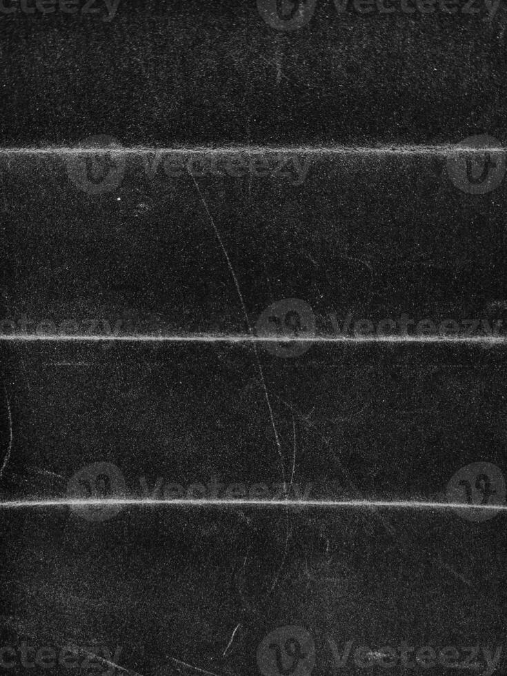 Beautiful Black grunge folded texture. Folded paper background with scratches and dust. Old folded paper texture for your design. photo