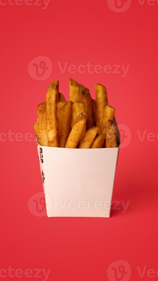 Frybox with fries, chicken, potato balls, pita and vegetables photo