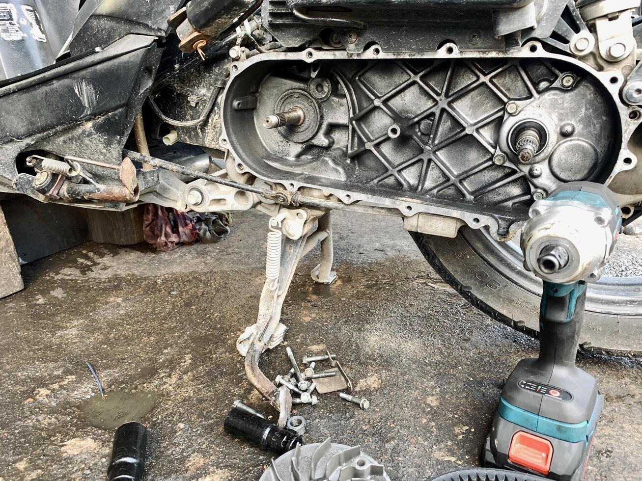 Motorcycle engine servicing is being carried out by a tool photo