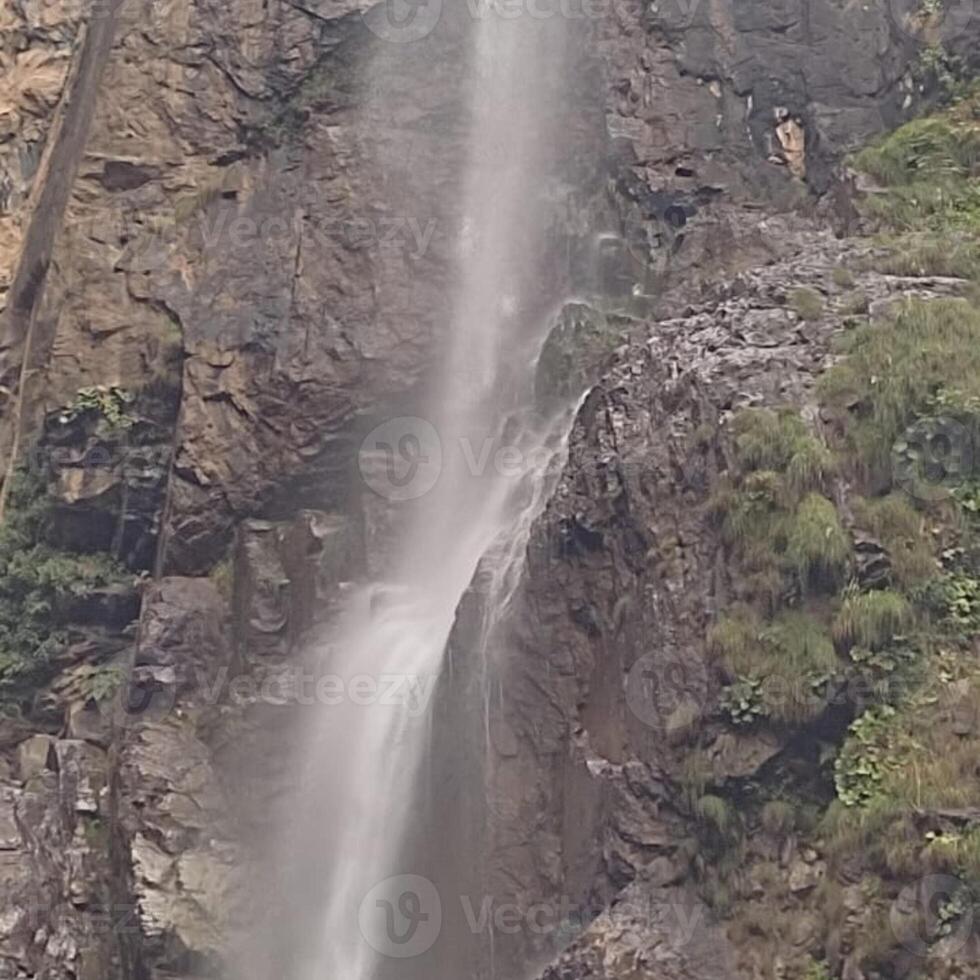 A waterfall, a mountain, or the glassy surface of a lake. photo