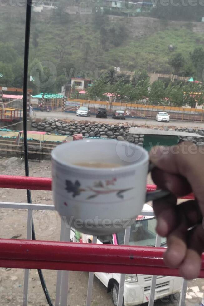 Hold a cup of coffee and drink at morning time photo