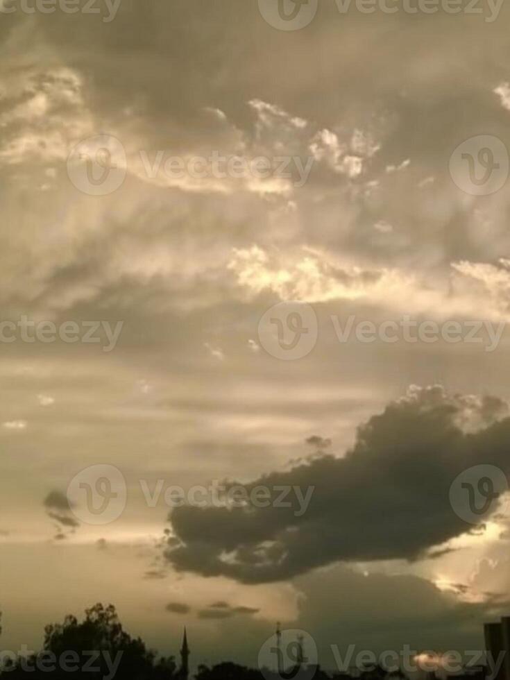 A beautiful view of cloudy sky behind the sunlight at the evening time. photo