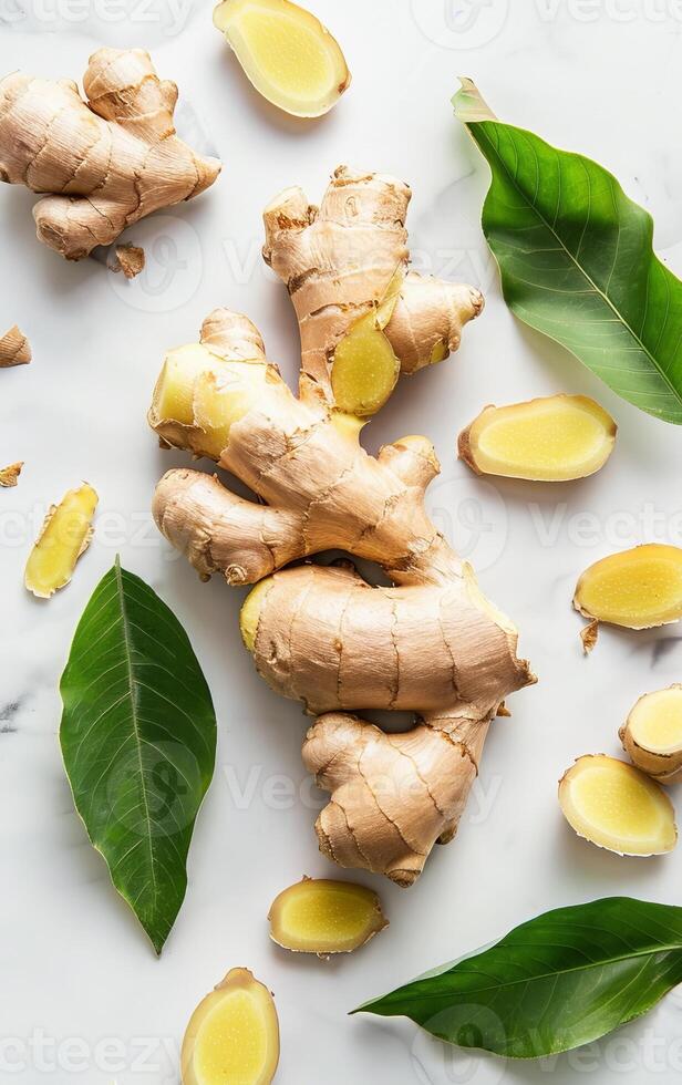 Fresh Ginger Root With Green Leaves on a White Background photo