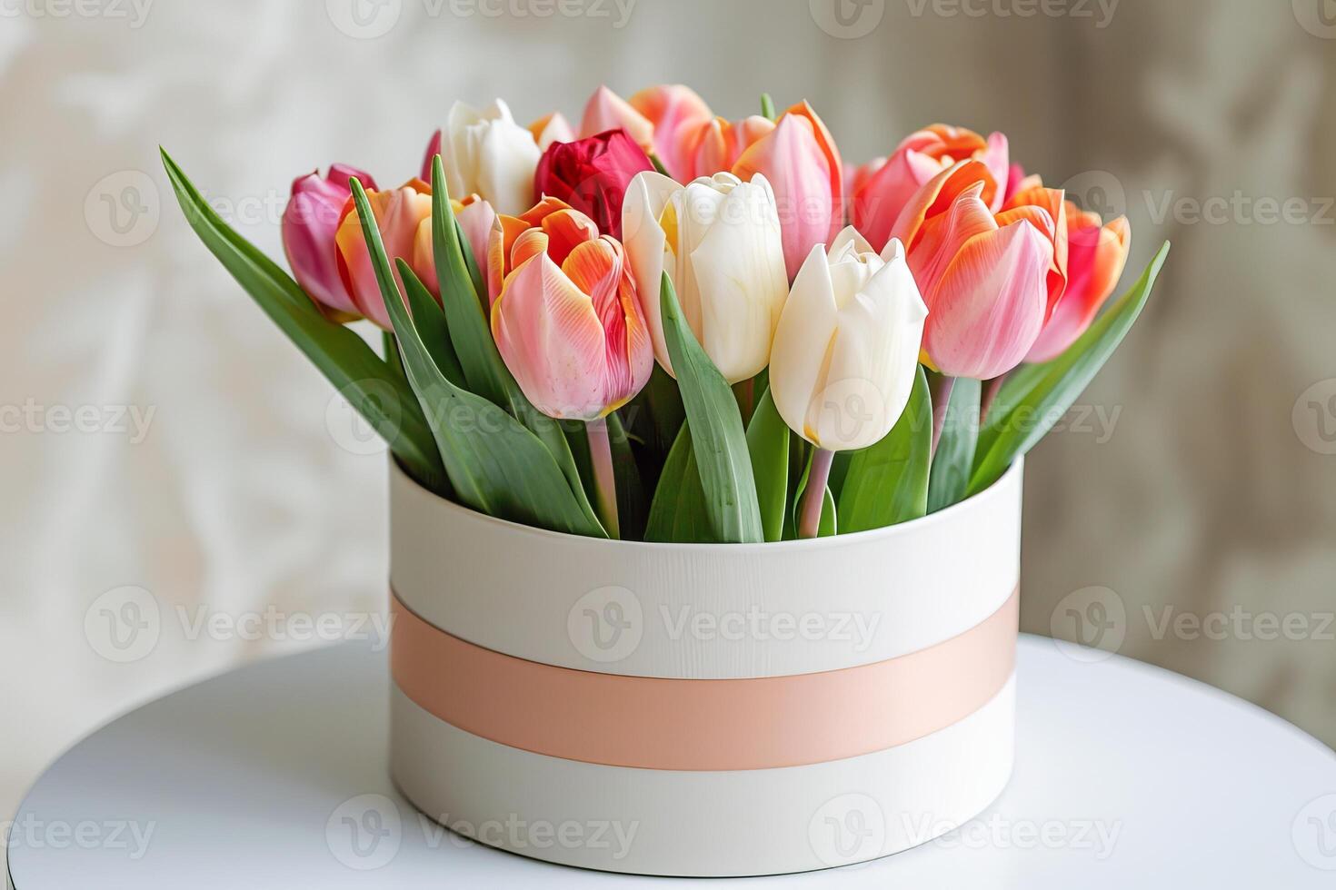 Elegant Bouquet of Pink and Yellow Tulips in a Round Gift Box by a Window photo