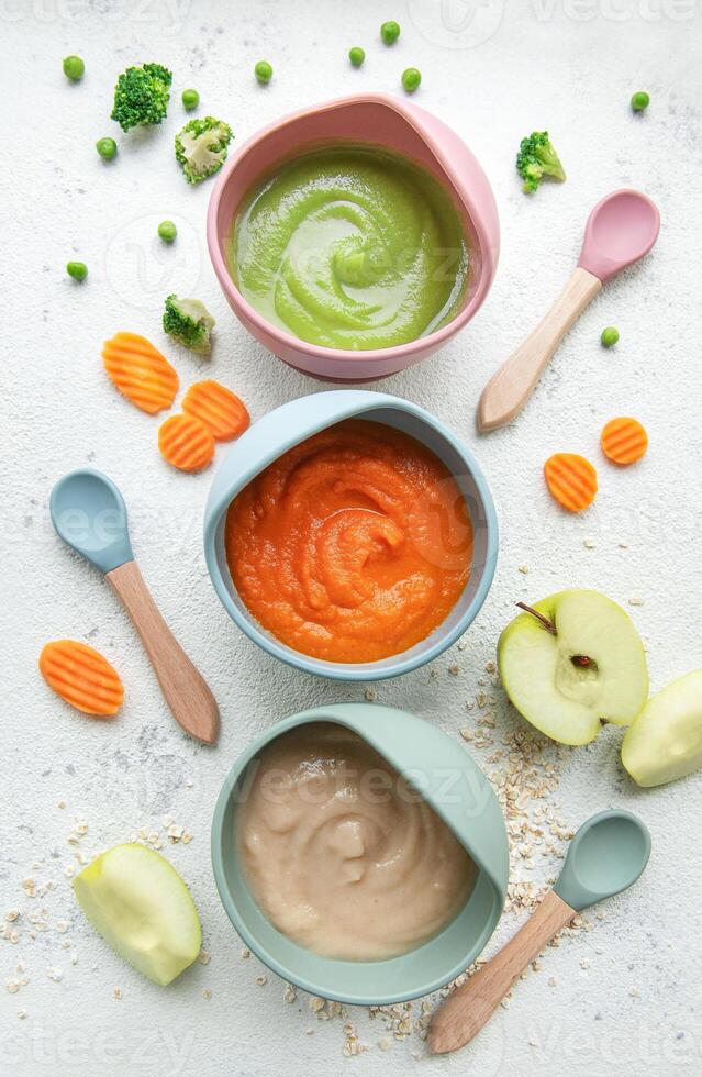 Healthy baby food in bowls photo