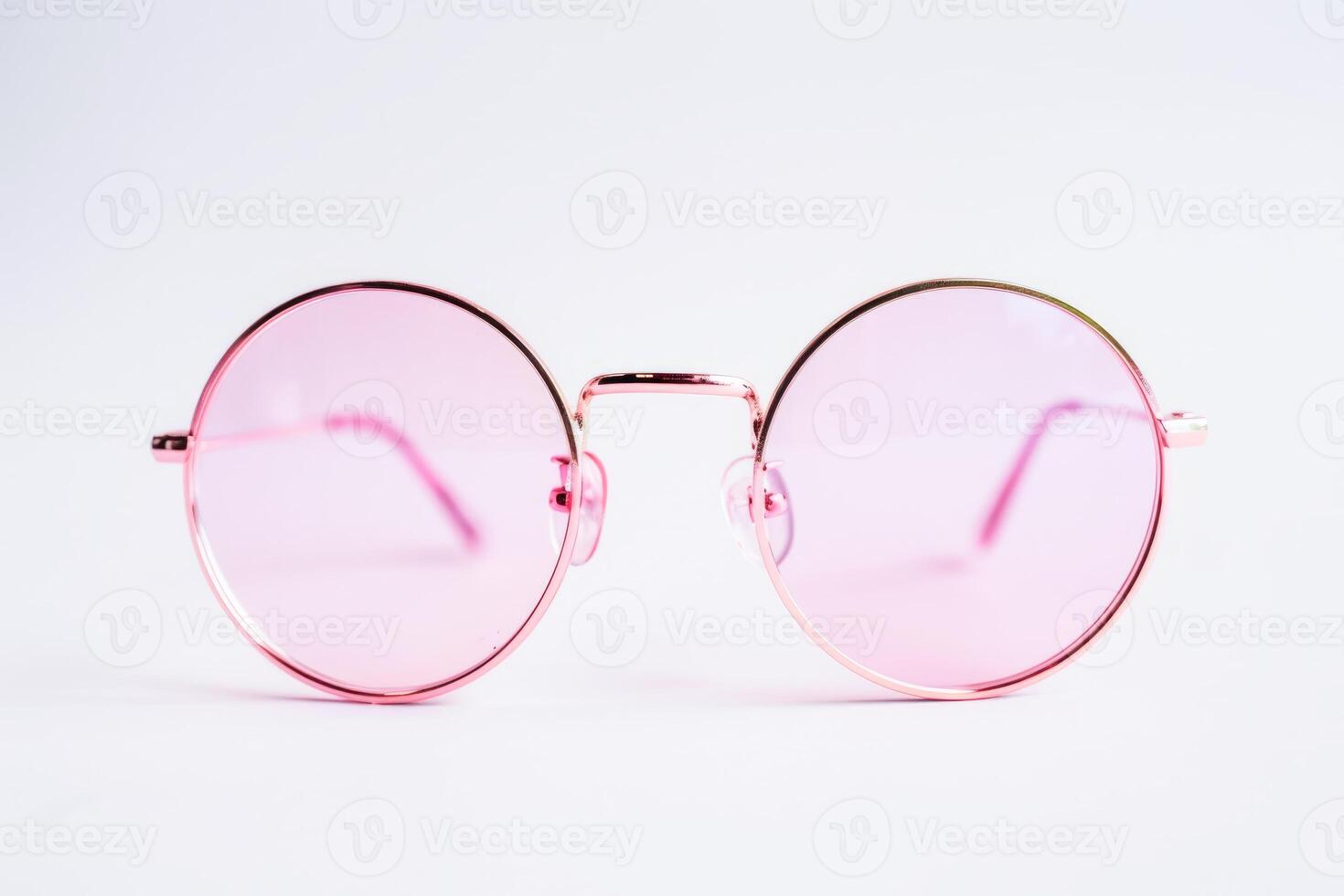 Elegant Round Rose Gold Glasses on a Soft Pink Background photo