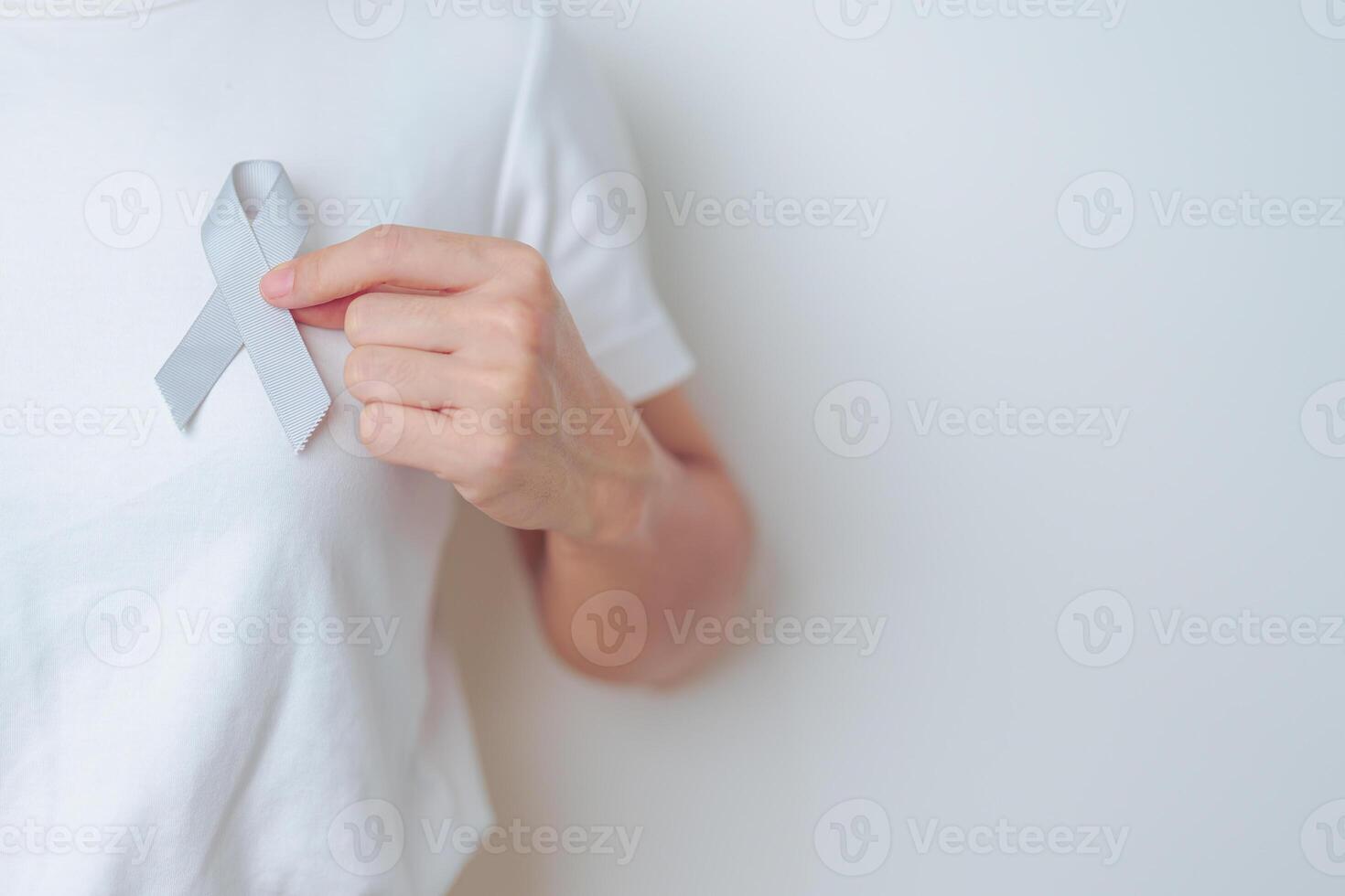 Brain Cancer Awareness May month, woman with grey color Ribbon for supporting life people. Healthcare and World cancer day concept photo