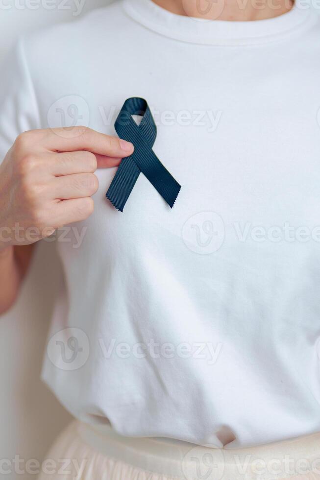 Melanoma and skin cancer, Vaccine injury awareness month and rest in peace concepts. woman holding black Ribbon photo