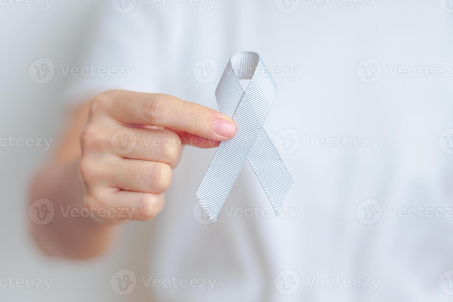Brain Cancer Awareness May month, woman with grey color Ribbon for supporting life people. Healthcare and World cancer day concept photo