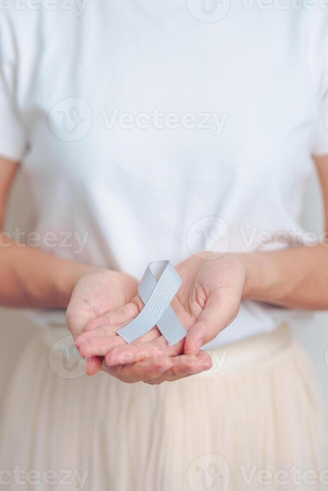 Brain Cancer Awareness May month, woman with grey color Ribbon for supporting life people. Healthcare and World cancer day concept photo