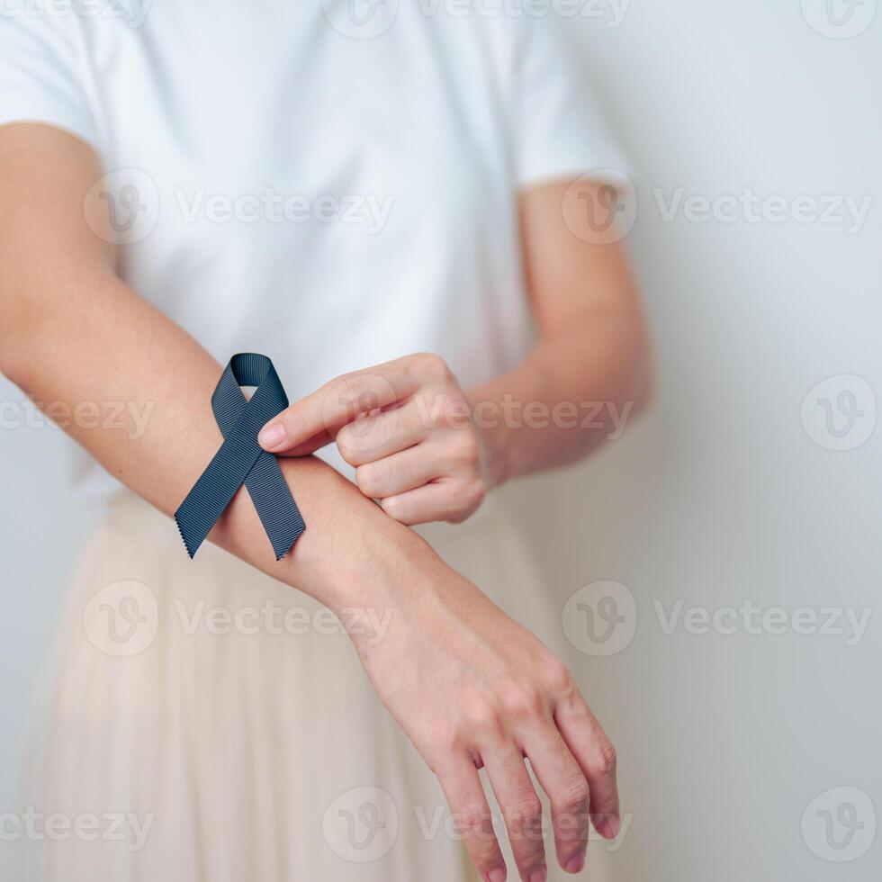 Melanoma and skin cancer, Vaccine injury awareness month and rest in peace concepts. woman holding black Ribbon photo