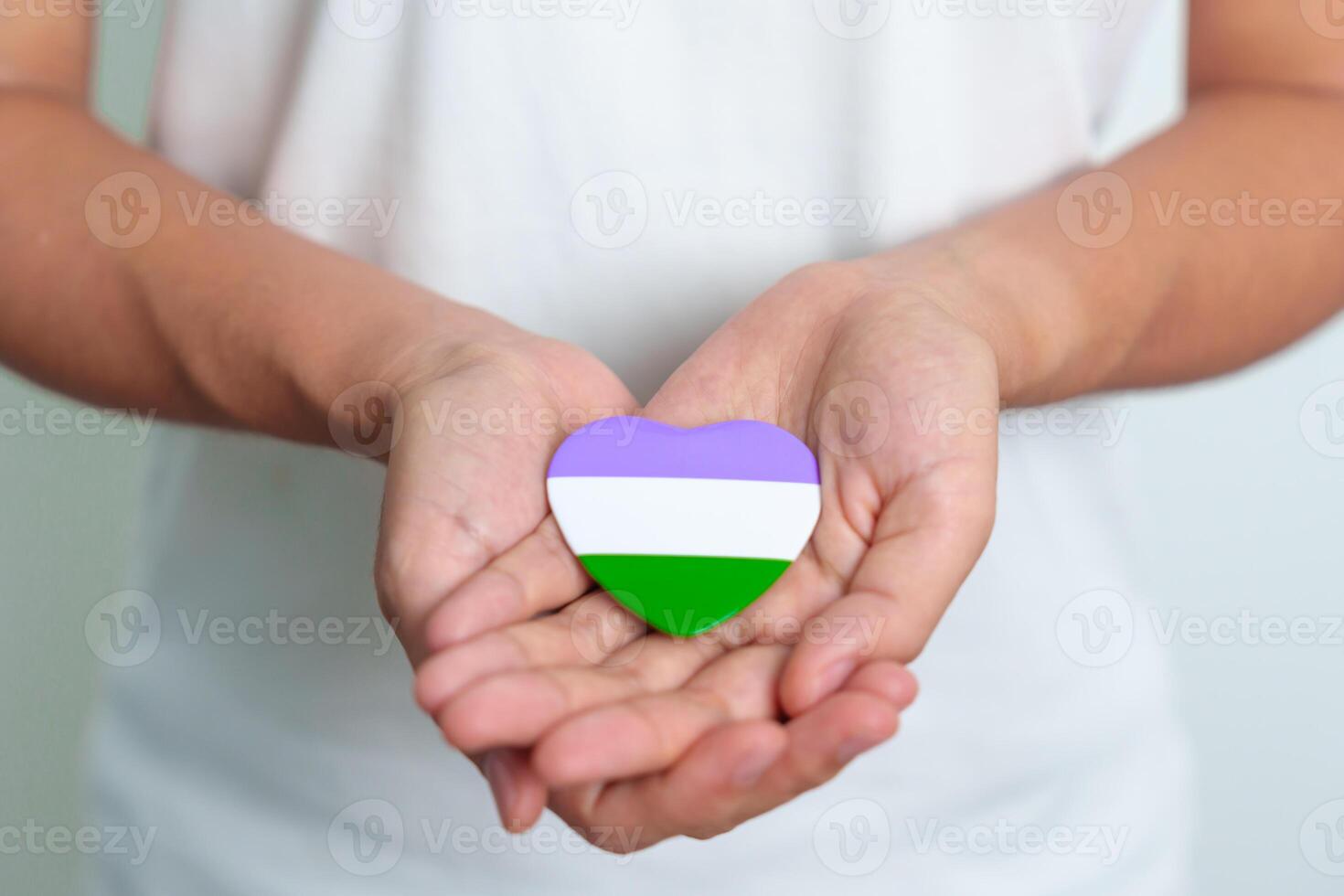 Queer Pride Day and LGBT pride month concept. purple, white and green heart shape for Lesbian, Gay, Bisexual, Transgender, genderqueer and Pansexual community photo