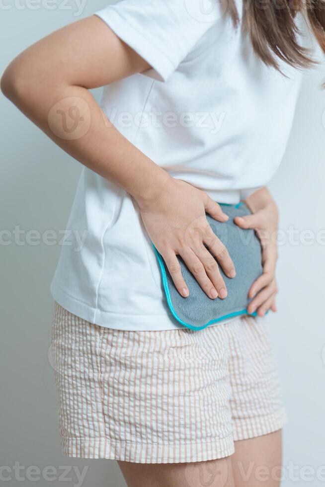 Menstruation period cycle of monthly and Stomachache concepts. woman having abdomen pain and menstrual ache with hot water bottle, illness female suffer from premenstrual ache and body Health problem photo