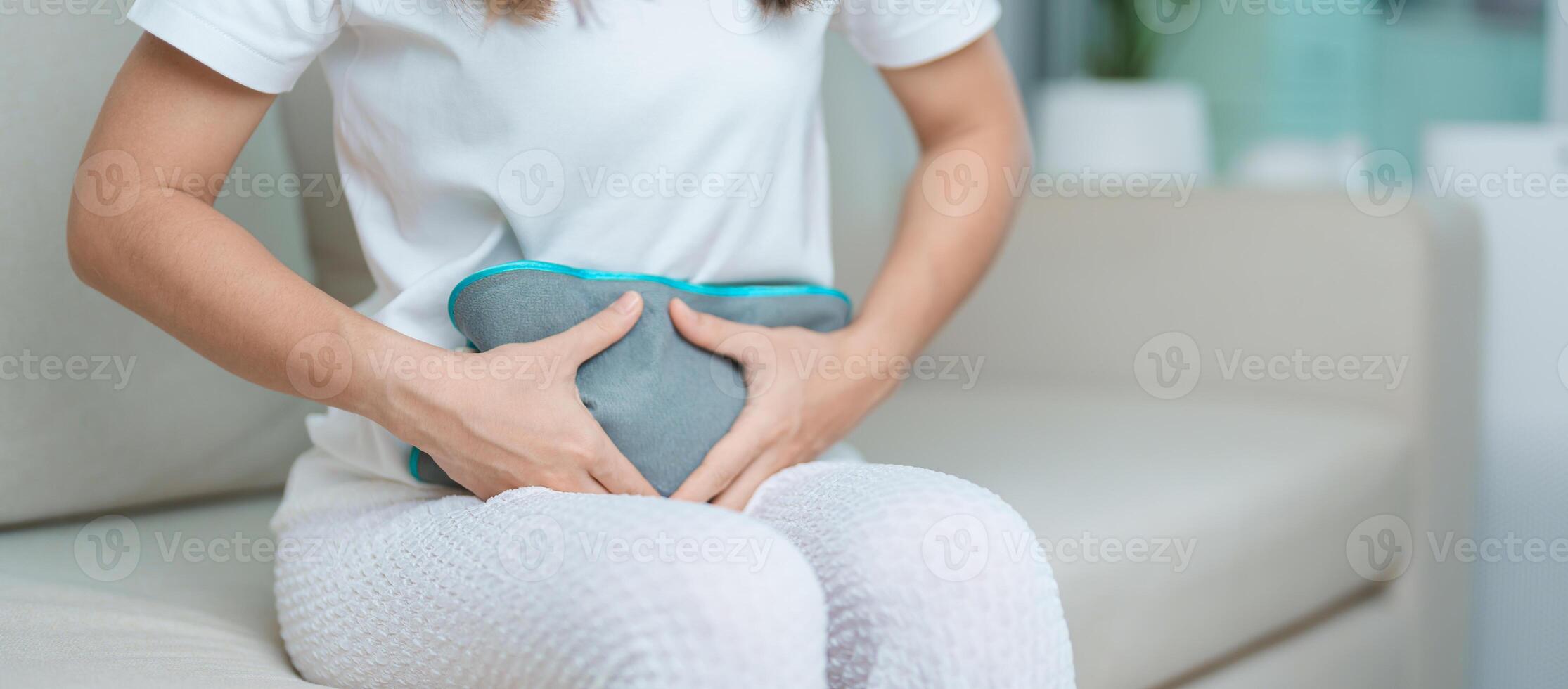 Menstruation period cycle of monthly and Stomachache concepts. woman having abdomen pain and menstrual ache with hot water bottle, illness female suffer from premenstrual ache and body Health problem photo
