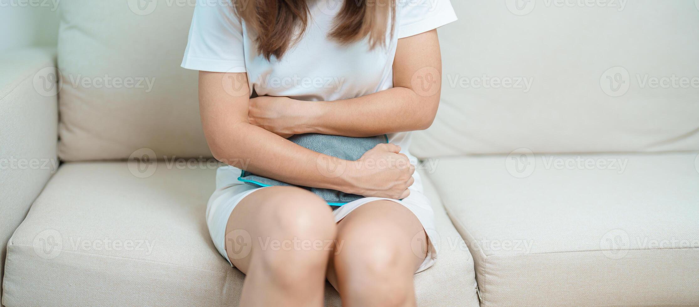 Menstruation period cycle of monthly and Stomachache concepts. woman having abdomen pain and menstrual ache with hot water bottle, illness female suffer from premenstrual ache and body Health problem photo