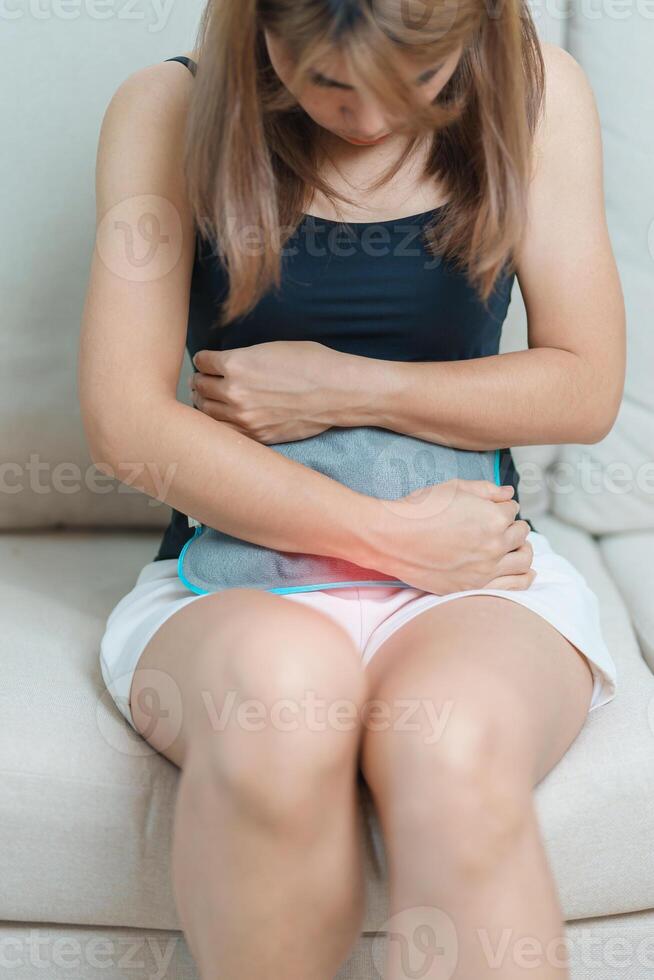 Menstruation period cycle of monthly and Stomachache concepts. woman having abdomen pain and menstrual ache with hot water bottle, illness female suffer from premenstrual ache and body Health problem photo