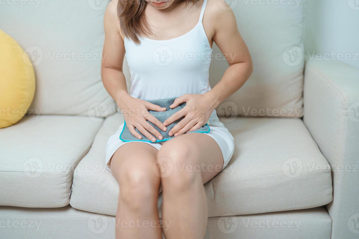 Menstruation period cycle of monthly and Stomachache concepts. woman having abdomen pain and menstrual ache with hot water bottle, illness female suffer from premenstrual ache and body Health problem photo