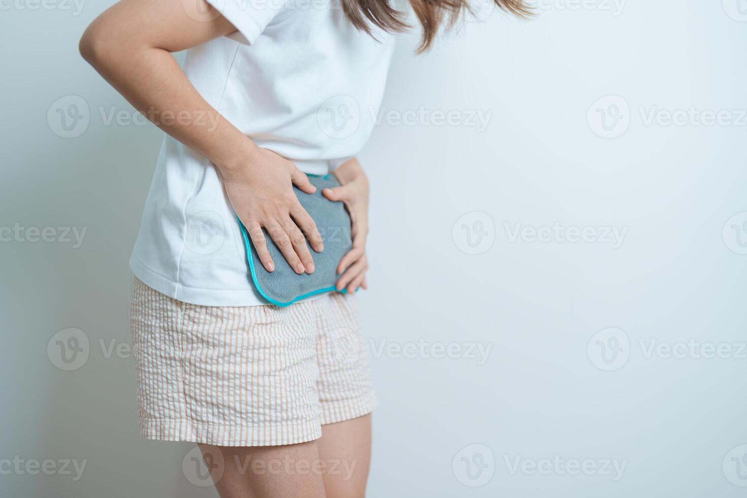 Menstruation period cycle of monthly and Stomachache concepts. woman having abdomen pain and menstrual ache with hot water bottle, illness female suffer from premenstrual ache and body Health problem photo