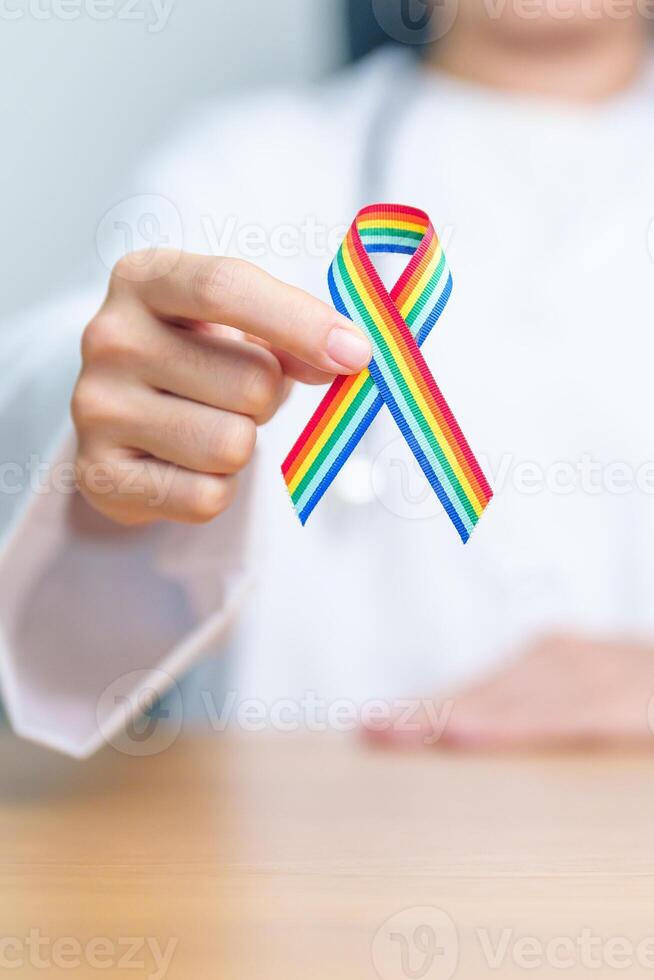 Doctor with LGBTQ Rainbow ribbon for Support Lesbian, Gay, Bisexual, Transgender and Queer community and happy Pride month concept photo