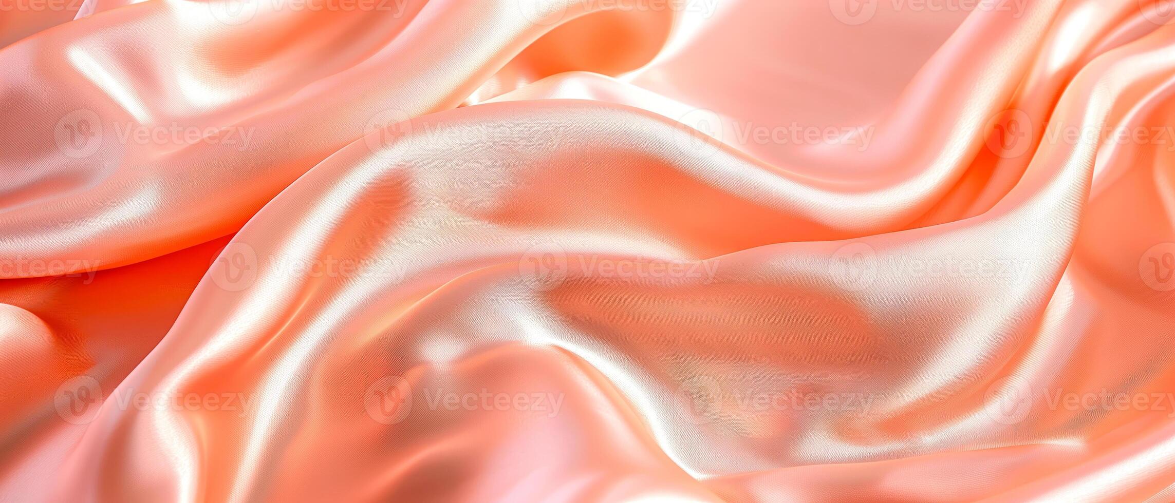 Close up of peach silk satin shiny fabric texture as background. Peach fuzz color on silky cloth curtain texture. photo