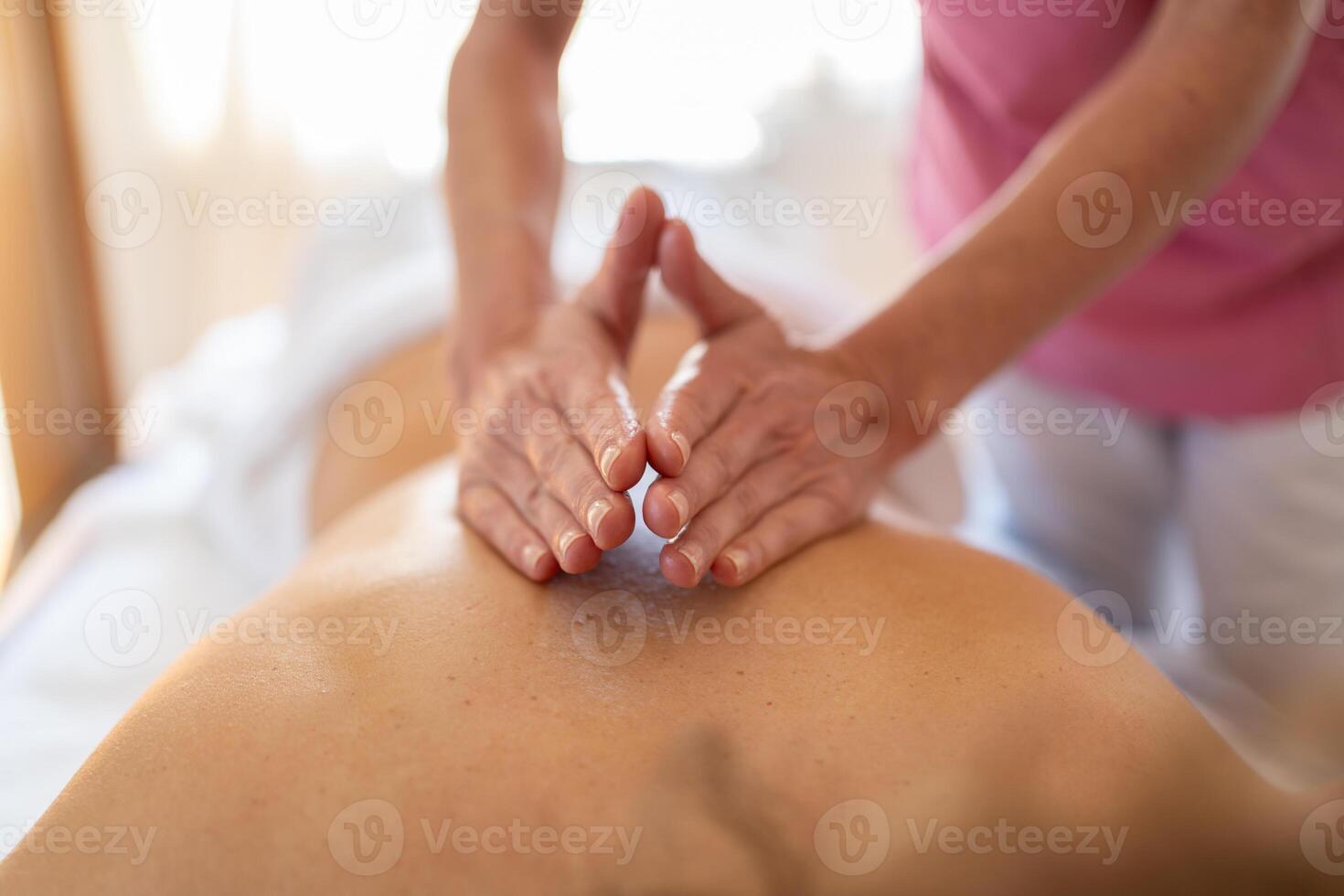 Masseuse doing massage with hands in recovery center photo