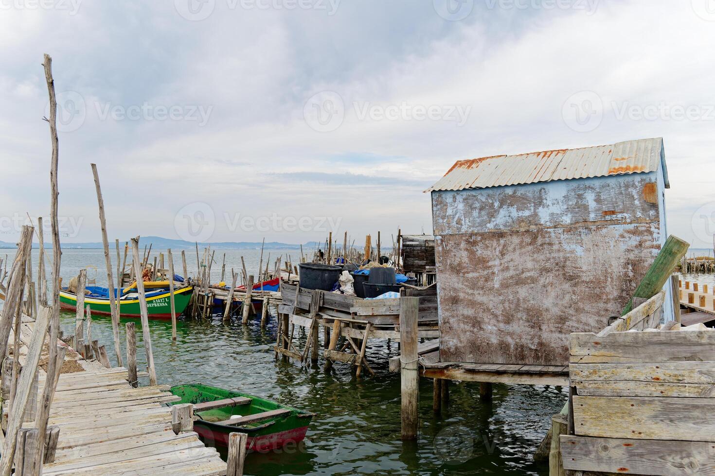 View of the Porto Palafita or Dock of Stilt Houses in Carrasqueira, Portugal. Serene and beautiful tourist attraction. Fishing village. photo