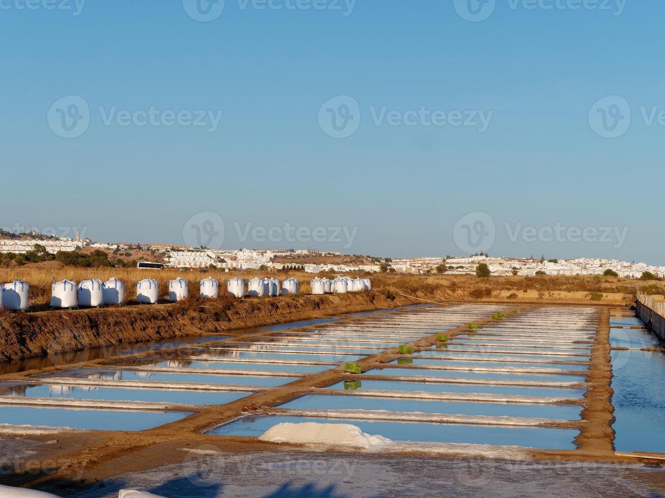 View of salt fields after a full day of collecting salt. Nice vibrant colors. Salt fields in Castro Marim, Portugal. Salt extraction. photo